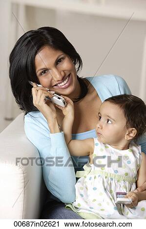 woman talking on mobile phone, baby on her lap View Large Photo Image Stock Image - woman talking on mobile phone, baby on her lap. Fotosearch