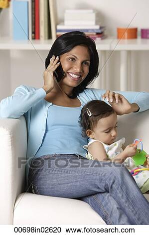 woman talking on mobile phone, sitting with baby View Large Photo Image Stock Image - woman talking on mobile phone, sitting with baby. Fotosearch