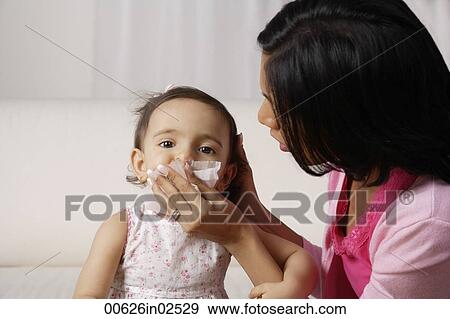 woman wiping her baby's mouth after meal View Large Photo Image Stock Photo - woman wiping her baby's mouth after meal. Fotosearch