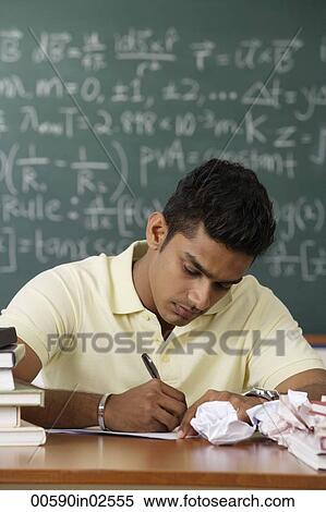 young man sitting at his desk, writing View Large Photo Image Stock Photography - young man sitting at his desk, writing. Fotosearch
