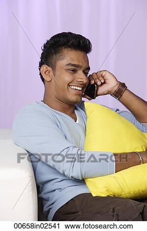 young man talking on mobile phone, relaxed View Large Photo Image Stock Image - young man talking on mobile phone, relaxed. Fotosearch
