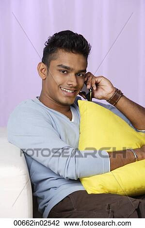 young man talking on mobile phone, relaxed View Large Photo Image Stock Image - young man talking on mobile phone, relaxed. Fotosearch