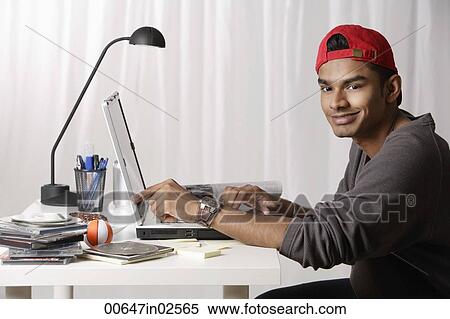 young man with red cap working on laptop View Large Photo Image Stock Photography - young man with red cap working on laptop. Fotosearch