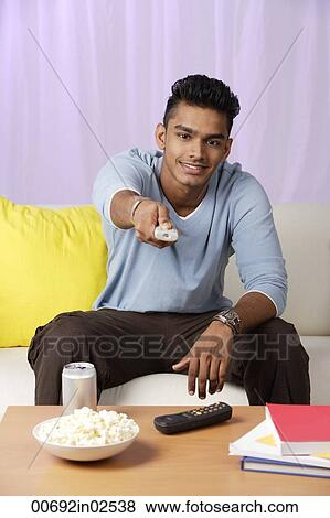 young man with television remote View Large Photo Image Stock Photo - young man with television remote. Fotosearch
