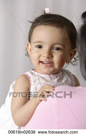 Stock Photo - young toddler smiling happily in mother's arms. Fotosearch