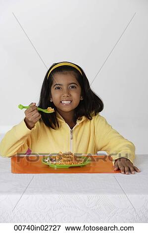 Girl eating briyani rice View Large Photo Image Stock Photo - Girl eating briyani rice. Fotosearch