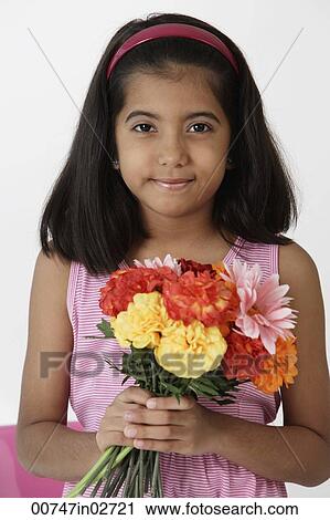 Girl holding bouquet of flowers View Large Photo Image Stock Image - Girl holding bouquet of flowers. Fotosearch