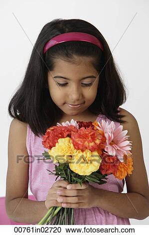 Stock Image - Girl holding bouquet of flowers. Fotosearch