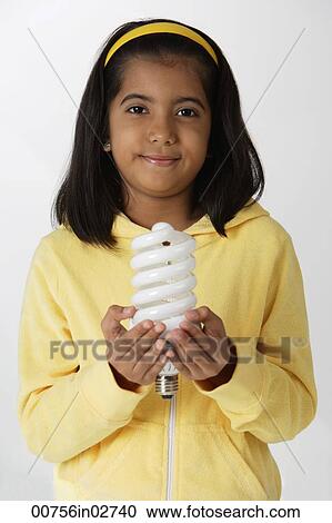 Girl holding light bulb View Large Photo Image Stock Image - Girl holding light bulb. Fotosearch