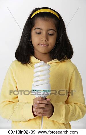 Girl holding light bulb View Large Photo Image Stock Photo - Girl holding light bulb. Fotosearch