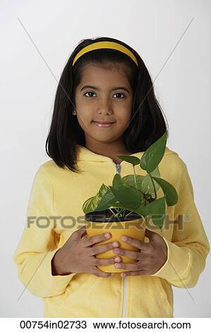 Girl holding plant View Large Photo Image Stock Image - Girl holding plant. Fotosearch