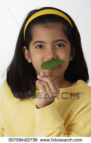Girl smelling green leaf View Large Photo Image Stock Photograph - Girl smelling green leaf. Fotosearch