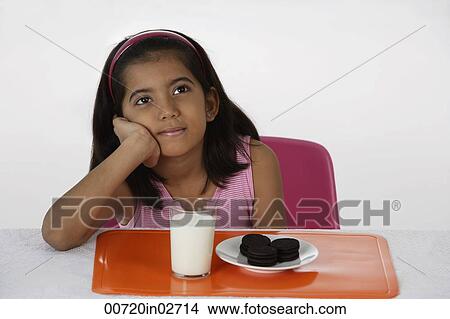 Girl with milk and cookies View Large Photo Image Picture - Girl with milk and cookies. Fotosearch