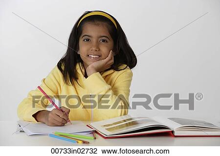 Girl working with color pencils and book View Large Photo Image Stock Image - Girl working with color pencils and book. Fotosearch