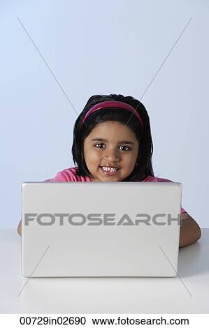 Little girl at laptop computer View Large Photo Image Stock Image - Little girl at laptop computer. Fotosearch