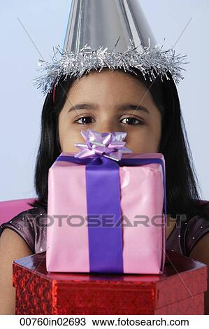 Little girl holding birthday presents View Large Photo Image Stock Image - Little girl holding birthday presents. Fotosearch