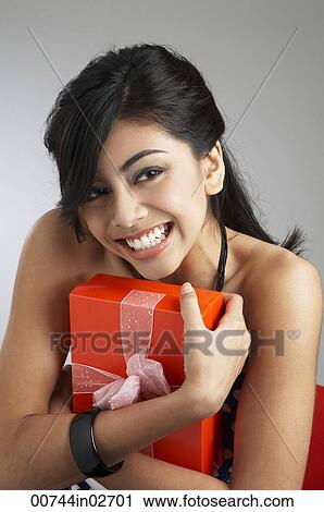 Young woman holding gift View Large Photo Image Stock Image - Young woman holding gift. Fotosearch
