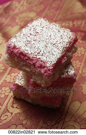 A stack of Indian pink sweets with silver topping. View Large Photo Image Stock Image - A stack of Indian pink sweets with silver topping.. Fotosearch