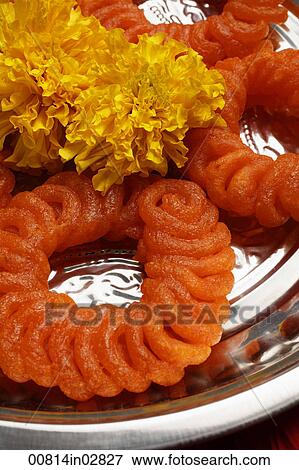 Stock Photo - Close up of Indian sweets with flowers.. Fotosearch