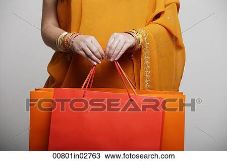 crop shot of woman in sari holding shopping bags View Large Photo Image Stock Image - crop shot of woman in sari holding shopping bags. Fotosearch