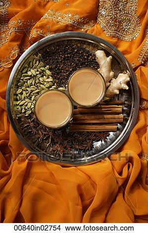 Picture - Indian masala tea with spices on silver tray.. Fotosearch