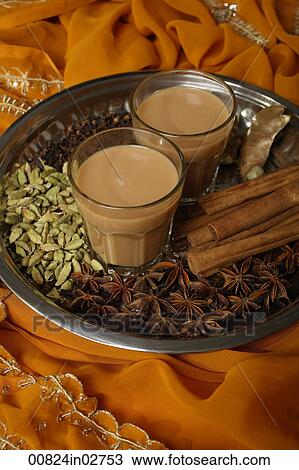 Stock Image - Indian masala tea with spices on silver tray.. Fotosearch