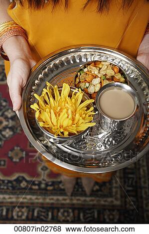 tight shot of a woman holding a tray of tea and snacks View Large Photo Image Stock Photo - tight shot of a woman holding a tray of tea and snacks. Fotosearch