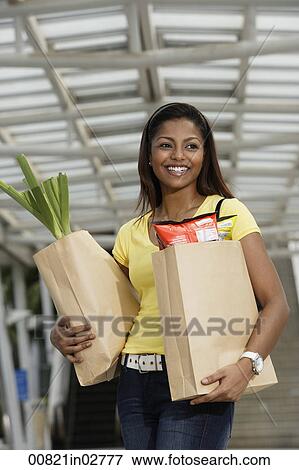 woman holding grocery shopping bags View Large Photo Image Stock Photo - woman holding grocery shopping bags. Fotosearch