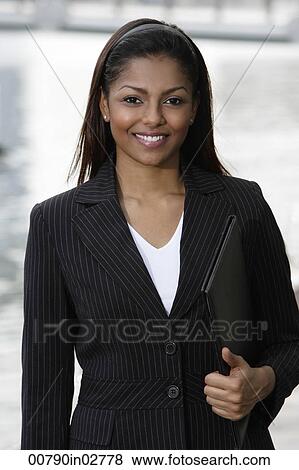 woman wearing business suit, holding folder View Large Photo Image Stock Photo - woman wearing business suit, holding folder. Fotosearch