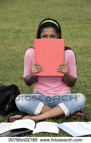 young woman laughing behind folder View Large Photo Image Stock Photo - young woman laughing behind folder. Fotosearch