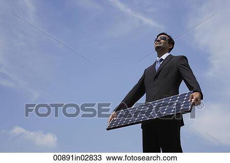 Businessman holding solar panel. View Large Photo Image Stock Image - Businessman holding solar panel.. Fotosearch