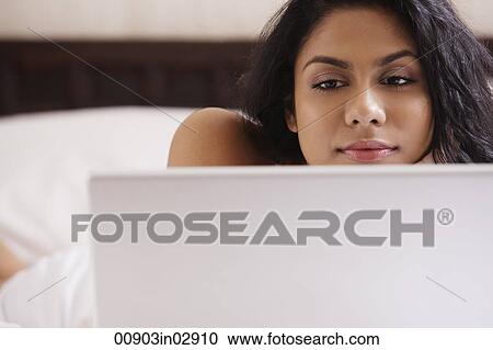 Closeup of Indian woman looking at computer View Large Photo Image Stock Image - Closeup of Indian woman looking at computer. Fotosearch