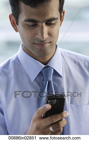 Head shot of Indian businessman reading text messages. View Large Photo Image Stock Image - Head shot of Indian businessman reading text messages.. Fotosearch
