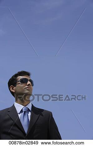 Indian businessman wearing sunglasses outside View Large Photo Image Stock Photo - Indian businessman wearing sunglasses outside. Fotosearch