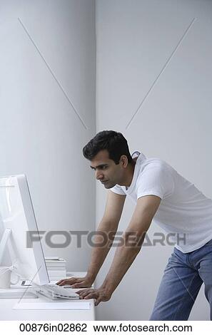 Indian man looking at computer. View Large Photo Image Stock Image - Indian man looking at computer.. Fotosearch