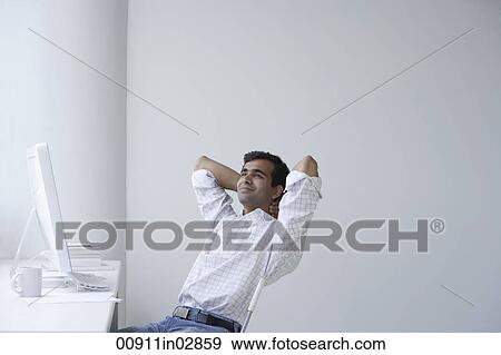 Indian man relaxing in front of the computer View Large Photo Image Stock Photo - Indian man relaxing in front of the computer. Fotosearch
