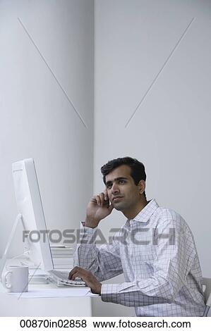 Indian man working on computer. View Large Photo Image Stock Photo - Indian man working on computer.. Fotosearch