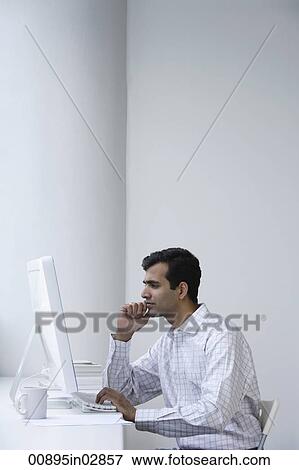 Indian man working on computer. View Large Photo Image Stock Photo - Indian man working on computer.. Fotosearch