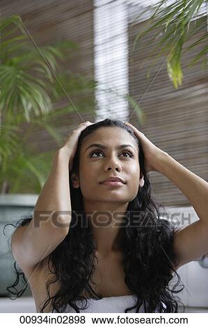 Indian woman looking up and holding her head View Large Photo Image Stock Photo - Indian woman looking up and holding her head. Fotosearch