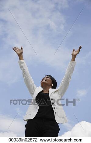 Indian woman looking up with arms reaching to the sky View Large Photo Image Stock Image - Indian woman looking up with arms reaching to the sky. Fotosearch