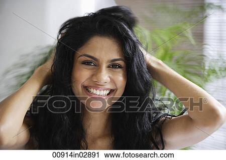 Indian woman smiling and playing with her hair View Large Photo Image Stock Image - Indian woman smiling and playing with her hair. Fotosearch