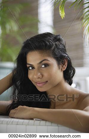 Indian woman taking a bath and looking at camera View Large Photo Image Stock Photo - Indian woman taking a bath and looking at camera. Fotosearch