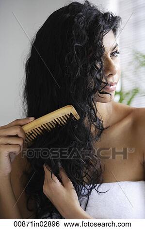 Indian woman with bare shoulders and combing her hair. View Large Photo Image Stock Photograph - Indian woman with bare shoulders and combing her hair.. Fotosearch