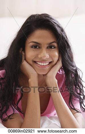 Portrait of Indian woman holding face and smiling View Large Photo Image Stock Image - Portrait of Indian woman holding face and smiling. Fotosearch