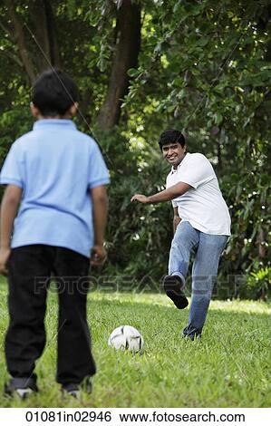 Father kicking ball to son View Large Photo Image Stock Photograph - Father kicking ball to son. Fotosearch