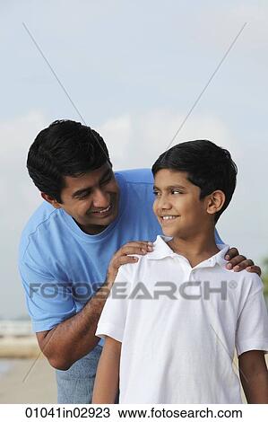 Father looking at son and smiling View Large Photo Image Stock Image - Father looking at son and smiling. Fotosearch