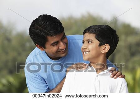 Father looking at son smiling. View Large Photo Image Picture - Father looking at son smiling.. Fotosearch