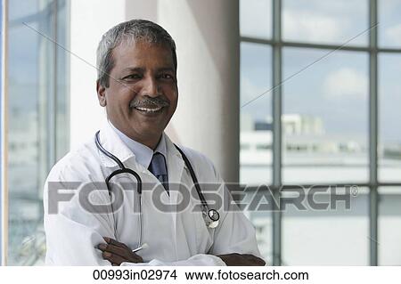 Head shot of Indian doctor smiling View Large Photo Image Picture - Head shot of Indian doctor smiling. Fotosearch