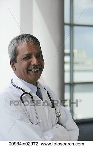 Head shot of Indian Doctor smiling View Large Photo Image Stock Image - Head shot of Indian Doctor smiling. Fotosearch