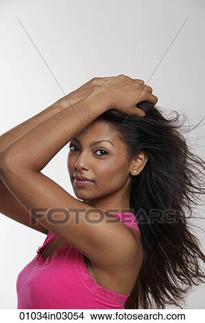 Head shot of Indian woman holding her head View Large Photo Image Picture - Head shot of Indian woman holding her head. Fotosearch